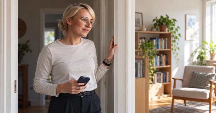 Woman pausing thoughtfully in a familiar-looking home doorway