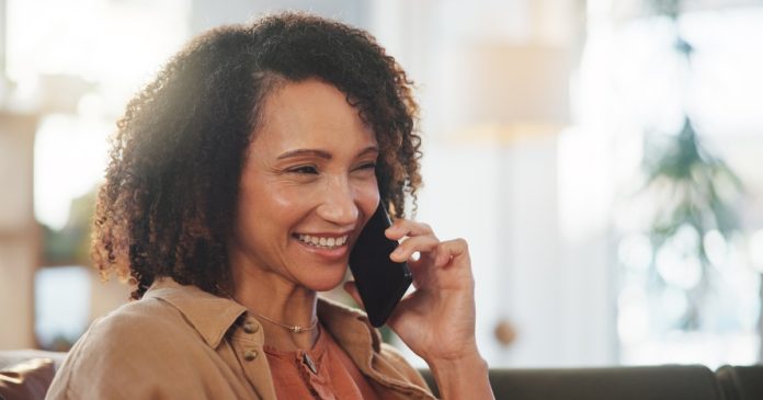 Tarot Reading Red Flags: Pressure, Payments and Privacy Woman at home pausing to consider a phone conversation