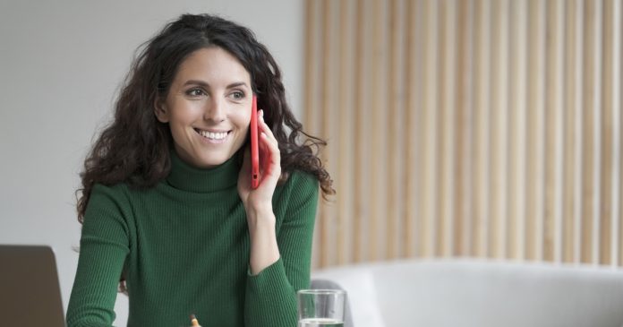 What a Twin-Flame Connection Can Invite You to Explore Woman taking notes during a phone conversation at home